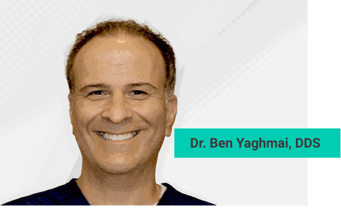 Dr. Ben Yaghmai, DDS, smiling, in dark dental scrubs